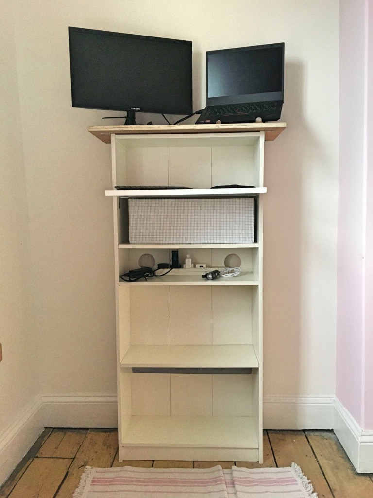 Standing desk with wall hanging