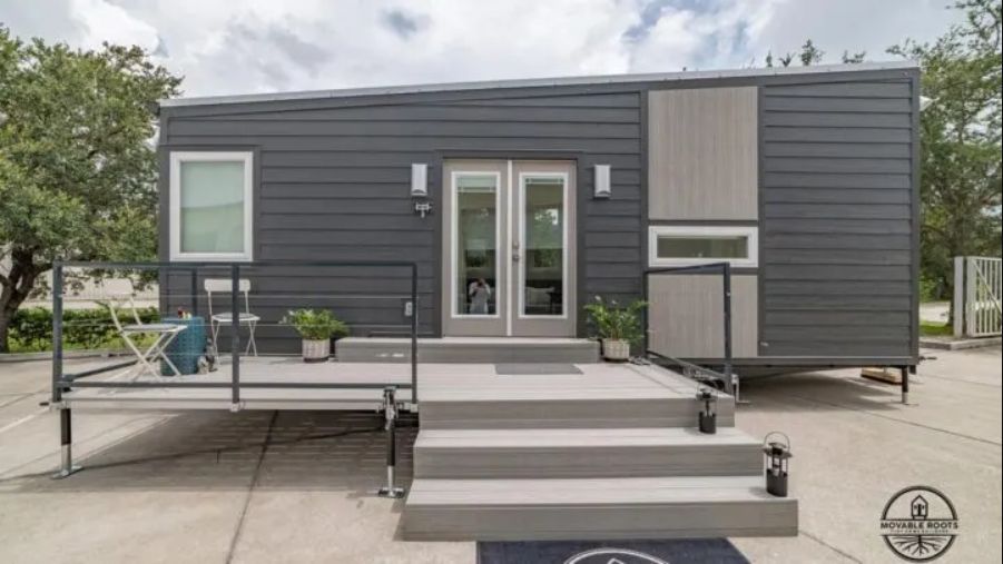 This tiny house has a deck at the front which basically extends the living area outside