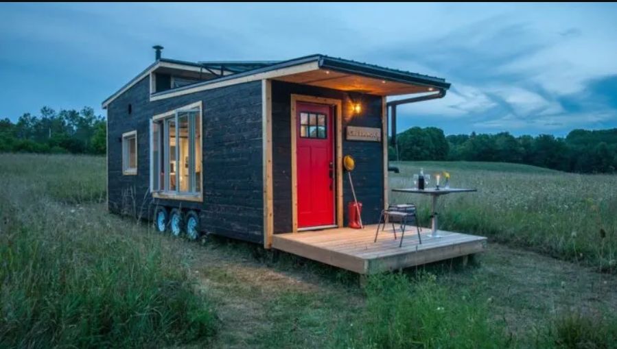 A Tiny House On Wheels That Has Its Own Draw Bridge Deck