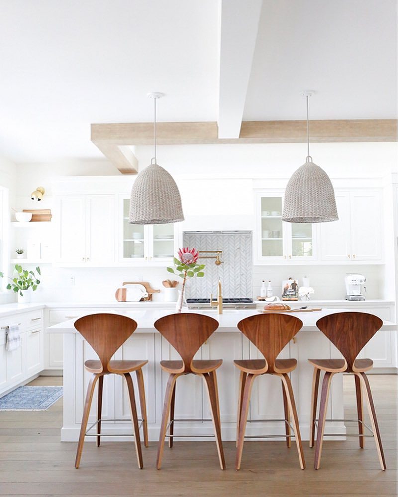 bell-shaped white-washed rattan pendant lights.