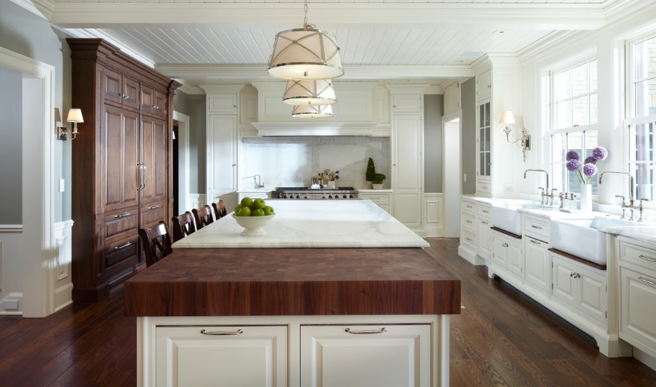 Farmhouse Kitchen with a Butcher Block Island and White Cabinets