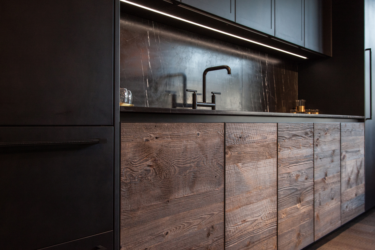 Kitchen featuring wooden cabinets and black marble backsplash